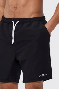 Tall Man Signature Mid Length Swim Shorts 7 Tall Man Signature Mid Length Swim Shorts -Ocean Streetwear male black tall man signature mid length swim shorts 1 3